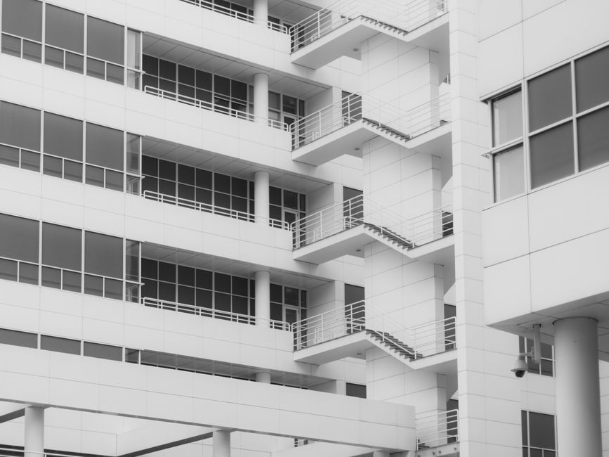 A minimalist, clean shot of an intricate white architectural model against a bright background, representing a well-structured framework for content.