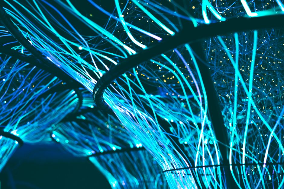An abstract, futuristic image of glowing blue and purple nodes connected by lines, representing the complex, AI-driven structure of the Agentic Web.