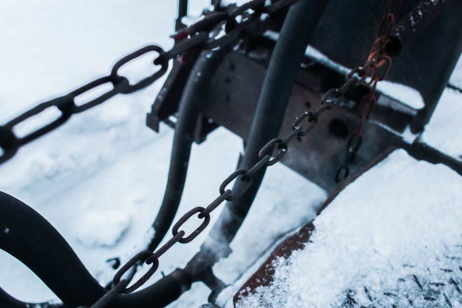 A dark, heavy metal chain with a single link glowing bright red, signifying a critical point of failure and a liability within a system like a PBN.