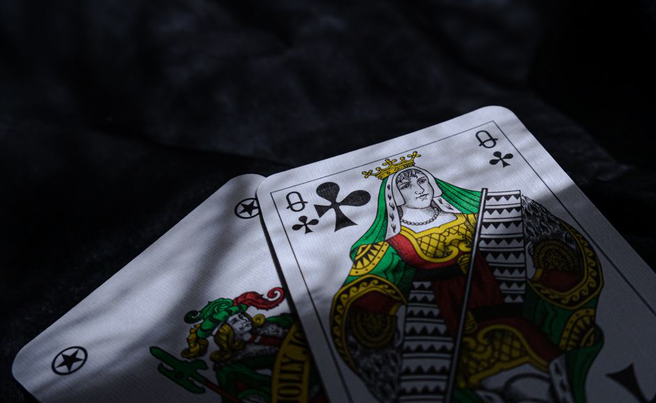 House of cards is captured mid-collapse against a dark, dramatic background, symbolizing the fragility and imminent failur...