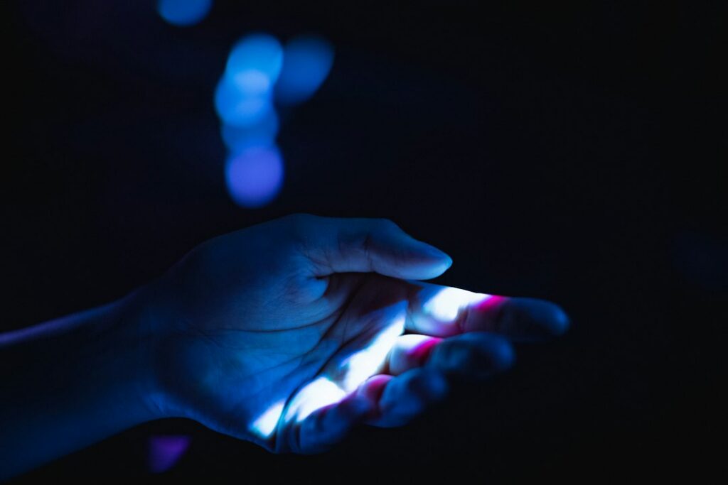 Person's hand reaches out to touch a complex, glowing digital network, symbolizing the connection between human strategy a...