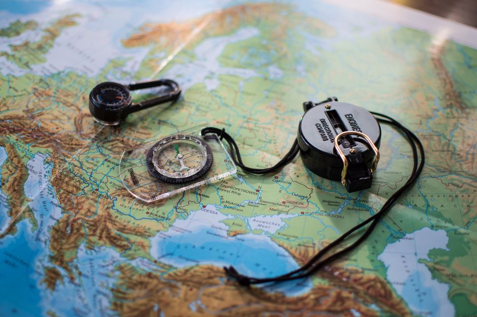 A sleek, modern compass resting on a clean map, indicating a change in direction and the path to transitioning clients to a new optimization model.