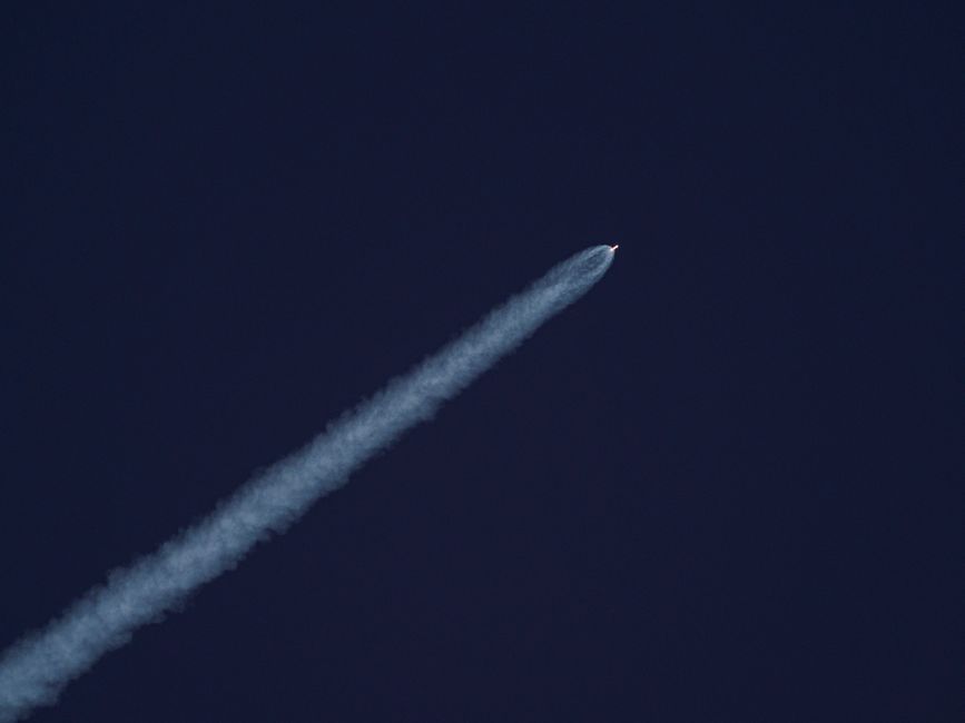 Sleek, modern rocket launching into a clear sky, symbolizing the speed and power of a day-one product launch.