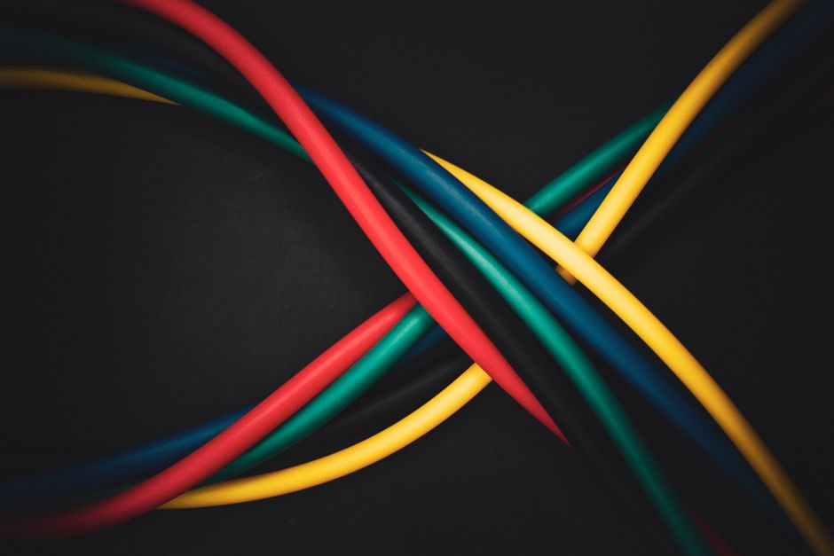 A macro shot of a dense, tangled mess of glowing fiber optic or network cables on a dark background, representing the complex and chaotic liability of an old backlink profile.