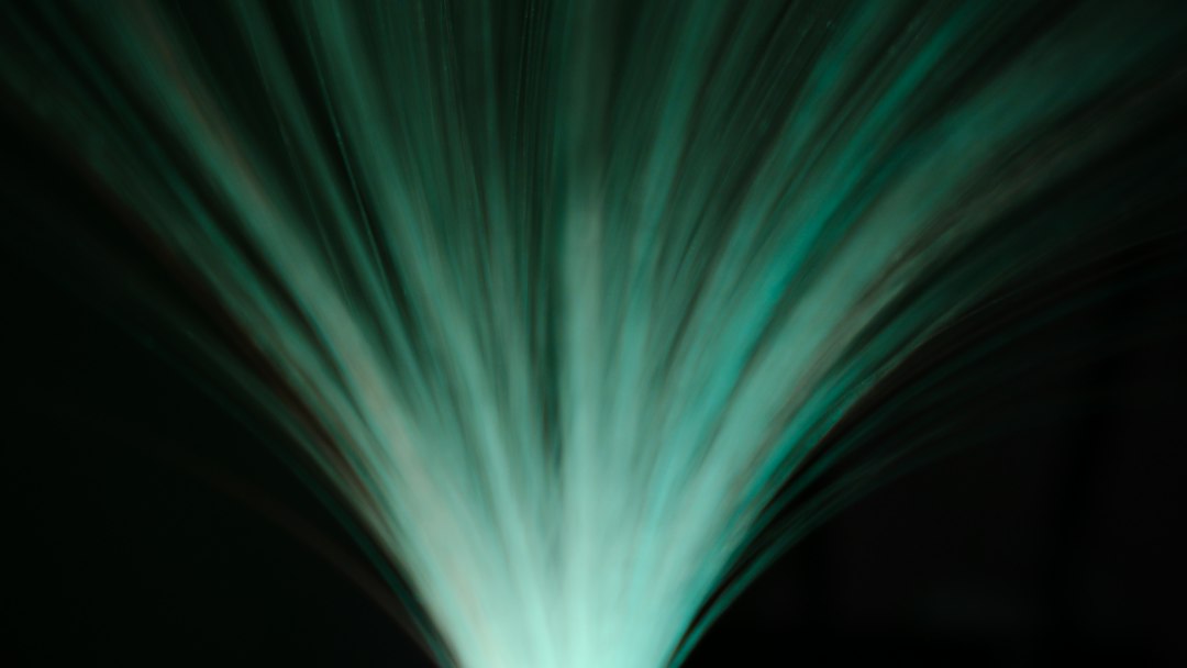 A minimalist photo of a clear liquid being poured into dark water, visually representing the concept of diluting negative data with positive information.